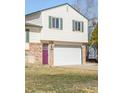 Two-story home with a two-car garage, brick accents and a lovely purple front door at 1812 24Th Ave, Longmont, CO 80501