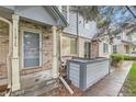 Attractive townhome with gray door, featuring a brick facade and well-kept front entry at 1121 W 112Th Ave # C, Denver, CO 80234