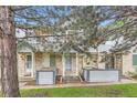 Inviting townhome with brick facade, a cozy front porch, and lush landscaping at 1121 W 112Th Ave # C, Denver, CO 80234