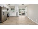 Bright eat-in kitchen featuring stainless appliances, white cabinetry, and access to backyard at 2260 S Lewiston St, Aurora, CO 80013