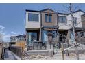 Contemporary townhome with brick facade, front patio, and modern architectural details on a sunny day at 5469 S Curtice St # L, Littleton, CO 80120