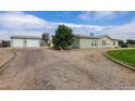 Single-story home with detached two-car garage and circular gravel driveway at 8481 Uinta St, Commerce City, CO 80022