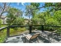 Serene backyard deck overlooking a pond and lush greenery, perfect for relaxing outdoors at 6505 W Hampden Ave, Lakewood, CO 80227