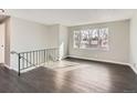 Open-concept living room featuring large windows, providing ample natural light, and sleek hardwood flooring at 5153 Scranton St, Denver, CO 80239