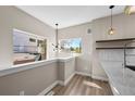 Bright eat-in kitchen nook with modern light fixtures and a view to the neighborhood at 2140 S Ash St # 105, Denver, CO 80222