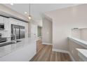 Bright modern kitchen with stainless steel appliances and hardwood floors at 2140 S Ash St # 105, Denver, CO 80222