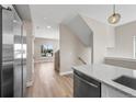 Open floor plan with kitchen island, stairway, and large window bringing in natural light at 2140 S Ash St # 105, Denver, CO 80222