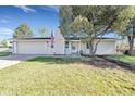 Cozy single-story home with an attached garage and a manicured front yard featuring a mature tree at 3561 W 131St Ave, Broomfield, CO 80020