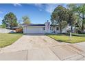Inviting single-story home featuring a spacious driveway, mature tree, and a well-kept front lawn at 3561 W 131St Ave, Broomfield, CO 80020
