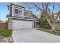 Well maintained home with large windows above the garage and a concrete driveway leading to the street at 9523 Sherrelwood Ln, Highlands Ranch, CO 80126