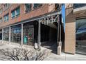 Modern brick building featuring sleek architectural details and prominent street-facing signage at 4144 Tennyson St # 212, Denver, CO 80212