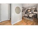 Bright entryway with hardwood floors, modern mirror, and open floor plan leading to the dining and kitchen at 4144 Tennyson St # 212, Denver, CO 80212