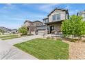 Inviting two-story home showcasing a manicured front yard and stone-accented porch at 19121 E 65Th Ave, Denver, CO 80249