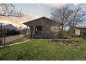 Inviting home featuring a well-maintained lawn and a cozy front porch at 575 2Nd St, Bennett, CO 80102