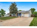 A charming one-story home, highlighted with vibrant blue trim and a well-maintained lawn, offers delightful curb appeal at 10007 Bryant St, Denver, CO 80260