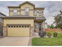 Beautiful home exterior featuring a two-car garage, stone accents, and well-kept lawn at 4862 S Piccadilly Ct, Aurora, CO 80015