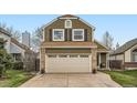 Charming two-story home featuring a brick facade, two-car garage and low-maintenance landscaping at 5648 S Youngfield Way, Littleton, CO 80127