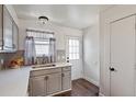 View of kitchen with stainless steel sink, light grey cabinets and hardwood floors at 8160 Washington St # 67, Denver, CO 80229