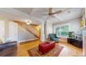 Spacious living room with hardwood floors, fireplace, and staircase access at 2456 S Marion St, Denver, CO 80210