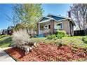 Charming brick home with landscaped front yard and mature trees, offering great curb appeal at 3336 N Saint Paul St, Denver, CO 80205