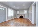 Spacious living room showcasing hardwood floors, fireplace, and neutral paint colors at 3336 N Saint Paul St, Denver, CO 80205