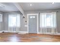 Bright living room featuring hardwood floors, fresh paint, and natural light from two windows at 3336 N Saint Paul St, Denver, CO 80205
