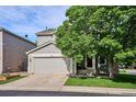 Charming gray two-story home featuring a two-car garage and well-maintained front yard at 1169 S Alton Ct, Denver, CO 80247