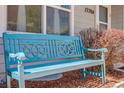 Up close, cozy blue bench is complemented by attractive bushes and front window at 12780 E Bethany Pl, Aurora, CO 80014