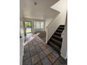 Inviting entryway with tile flooring that transitions to carpet, and staircase leads to the upper level at 4064 S Himalaya Way, Aurora, CO 80013