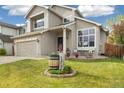 Inviting home exterior with a well-kept lawn, charming barrel accents, and an attached two-car garage at 3305 W 126Th Ave, Broomfield, CO 80020