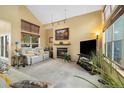 Bright living room with a cozy fireplace, comfortable seating, and large windows offering plenty of natural light at 3305 W 126Th Ave, Broomfield, CO 80020