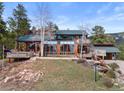 Charming home featuring multiple decks, a daylight basement, complemented by a stone pathway and scenic surroundings at 13660 Rampart Dr, Conifer, CO 80433