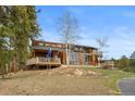 Attractive exterior featuring multiple decks, natural landscaping, and charming stone accents, enhancing its curb appeal at 13660 Rampart Dr, Conifer, CO 80433