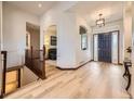 Bright and airy foyer featuring elegant hardwood floors and archways to other rooms at 10050 Eagle Valley Way, Highlands Ranch, CO 80129