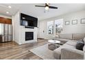 Living room featuring a fireplace, large TV, and comfy seating at 21835 E Radcliff Cir, Aurora, CO 80015