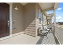 Inviting front porch with seating, perfect for enjoying outdoor relaxation at 12547 Lake View St, Longmont, CO 80504