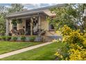 Inviting front porch with seating, showcasing a well-maintained facade and landscape at 4528 W 34Th Ave, Denver, CO 80212
