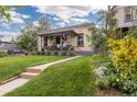 Inviting front porch and lush lawn, showcasing a well-maintained facade with landscaping at 4528 W 34Th Ave, Denver, CO 80212