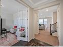 Bright hallway with a view of the living room, featuring an office space with French doors at 14850 Oslo Ave, Parker, CO 80134