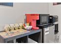 Convenient coffee station with a Keurig machine, microwave, and mini fridge at 17077 E 111Th Ave, Commerce City, CO 80022