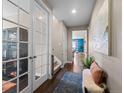 Inviting hallway with hardwood floors, a decorative rug, and bright natural lighting at 17077 E 111Th Ave, Commerce City, CO 80022