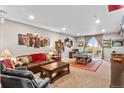 Spacious living room featuring a pool table, comfortable seating, and natural light at 17077 E 111Th Ave, Commerce City, CO 80022