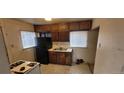 Functional kitchen featuring classic wood cabinets, a refrigerator, and stainless steel double-basin sink at 3607 W 80Th Ave, Westminster, CO 80030