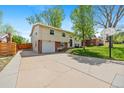 Split level home with a basketball hoop, nice yard and mature trees at 8022 S Jay Dr, Littleton, CO 80128