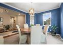 Formal dining room with stylish blue walls, a round table, and decorative light fixture at 14284 Double Dutch Cir, Parker, CO 80134