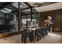 Modern dining room with wood table, large glass window views and stylish accents at 2415 Urban St, Lakewood, CO 80215