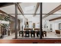 Open floor plan with view of the dining and kitchen area, framed by large glass windows at 2415 Urban St, Lakewood, CO 80215