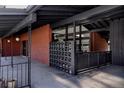 Mid-century modern home exterior with brick accents, black beams and breezeway at 2415 Urban St, Lakewood, CO 80215