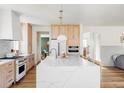 Bright kitchen featuring modern countertops, wood cabinets, and stainless steel appliances at 1221 W 144Th Ct, Westminster, CO 80023