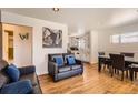 Comfortable living room with hardwood floors, stylish sofas, bright lighting, and an inviting atmosphere at 7146 Jennie Dr, Denver, CO 80221